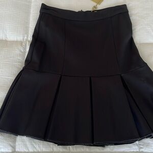 TORN BY RONNY KOBO. Black skirt with pleated hem. Size M. NWT
